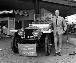 Lord Montagu with 1909 Rolls - Royce Silver Ghost at 1964 World's Fair, New York. Creator: Unknown.