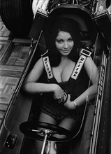 Female model in cockpit of Cooper F5000 at 1969 Racing Car show. Creator: Unknown.