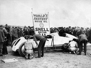BABS with Parry Thomas, having wheel changed at Pendine sands 1926. Creator: Unknown.