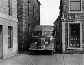1939-1952 Bedford OB coach in narrow street. Creator: Unknown.