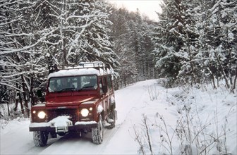 2001 Land Rover Defender driving in snowy conditions. Creator: Unknown.