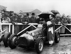 RRA Supercharged Special , G.N. Richardson in paddock at Aintree 1954. Creator: Unknown.