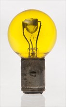 Yellow headlamp bulb. Creator: Unknown.