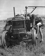 Fordson tractor, with Land girl 1940's. Creator: Unknown.