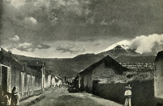 'Typical Side Street in Mexican Village: The Town of Ameca and Cloud-Effect on Popocatepetl', 1919. Creator: Unknown.