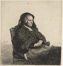 The artist's mother seated at a table, c.1631. Creator: Rembrandt Harmensz van Rijn.