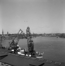Lifting cranes at the city courtyard, Stockholm harbour, Sweden, 1950. Creator: Unknown.