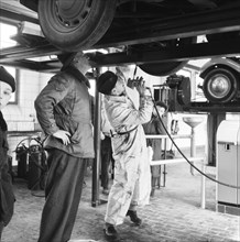 Tyre lubrication of passenger car, Stockholm, Sweden, 1955. Creator: Unknown.