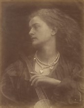 And Enid Sang, September 1874. A woman (Emily Peacock) wears two strands of pearls and holds a stringed instrument. A photographic illustration to Alfred Tennyson's "Idylls of the King"; a series of n...