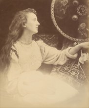 Elaine the Lily - Maid of Astolat, 1874. A seated woman (May Prinsep) in profile with long unbound hair. A photographic illustration to Alfred Tennyson's "Idylls of the King"; a series of narrative po...