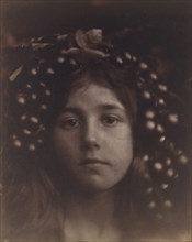Circe, 1865. A child (Kate Keown) with grapes and leaves around her head, in close-up and slightly out of focus, with the subject looking straight into the camera. Circe is an ancient Greek enchantres...