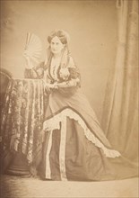 [La Comtesse at Table Holding Fan], 1860s.