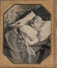 Postmortem Baby, Partially Covered by a Flowered Shawl with a Fringe Hem, 1840s.