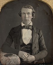 Seated Young Man Resting Arm on Table Beside Daguerreotype Case, 1840s.