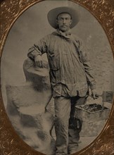 Workman Holding Brush and Rectangular Tray, Arm Resting on Fake Rock, 1860s-80s.
