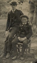 Two Young Men Outdoors, One Seated, the Other on the Arm of the Chair, 1880s.