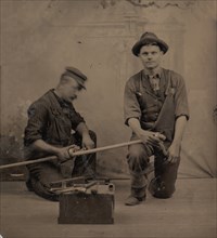 Two Plumbers with a Pipe, Pipe Cutter, and Toolbox, 1870s-80s.