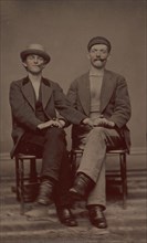 Two Seated Young Men Holding Hands, 1880s.