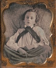 Boy Seated Cross-legged, Partially Covered by Blanket, Leaning Against Cushion, 1850s.