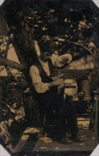 Tinsmith Working Under a Tree, 1870s.