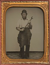 Man Gripping Sledgehammer, Wearing Leather Half Apron and Cap, 1850s-60s.