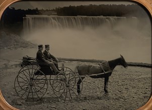 Two Men Seated in a Horse-Drawn Carriage in Front of Niagara Falls, 1860s.