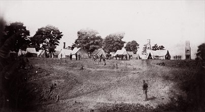 [Unidentified camp with ruined chimneys in background]. Brady album, p. 130, 1861-65. Formerly attributed to Mathew B. Brady.