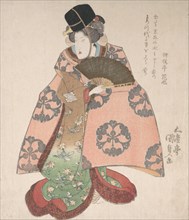 Kabuki Actor in a Female Role Standing with a Fan, 19th century., 19th century. Creator: Utagawa Kunisada.