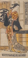 Actor Tsu-uchi Monsaburo in a Woman's Role in the Play "Three Instances of Good Fortune (Sanpuku Tsui)", ca. 1730.