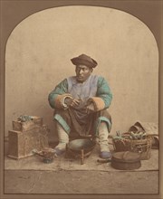 [Chinese Man Sitting with Tools], 1870s.