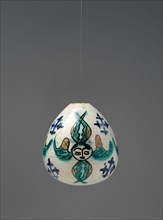 Egg-Shaped Ornament, Armenian, mid-18th century. Winged seraphim heads  with Crusader crosses. Porcelain eggs hung over altars and on lamp cords to prevent rodents and insects from reaching the lamp o...