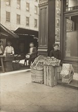 Lena Lochiavo - 11 years old, basket (and pretzel) seller, at Sixth Street Market in front of saloon entrance, Cincinnati, Ohio, 3136.
