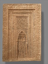 Tombstone in the Form of an Architectural Niche, Iran, dated A.H. 753/A.D. 1352.  Kufic inscriptions include the profession of faith known as the Shahada and passages from the Qur'an.