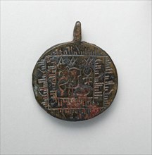Pendant with Lion and Scorpion, Iran, 10th century. Believed to be a talisman