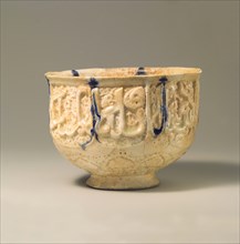 Pierced Bowl Signed by Hasan al-Qashani, Iran, late 11th-early 12th century. Auspicious words 'glory, prosperity, blessed power, and mercy to its owner' are inscribed in cursive script
