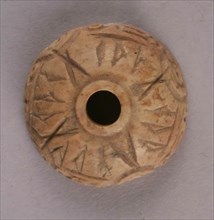 Spindle Whorl, Iran, 9th-10th century.  Excavated at Nishapur, providing evidence the city possessed a thriving textile industry