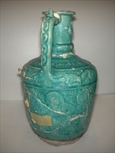 Ewer with Molded Inscriptions, Animals and Dancers, Iran, last quarter 11th or 12th century. Inscription mentions the name of the potter, Abu Ahmad Qassa?i. Choral dances performed at the time include...