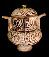 Two-Spouted Vessel with a Lid, Syria or Iran, 12th century. With an inscription in pseudo-kufic script.