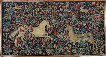 A unicorn and a stag in a field of flowers , c. 1500. Private Collection.