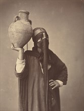 Porteuse d'eau au Caire [Water Carrier in Cairo], c. 1870.