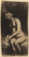 Nude Seated on a Bench with a Pillow (Woman Bathing Her Feet at a Brook), 1658.