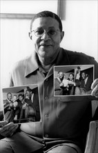 Bob Cranshaw, Swinging Jazz Party, Blackpool, 2005; backstage holding photos of the Junior Mance Trio taken by Brian Foskett.
