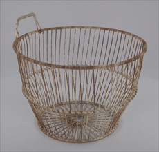 A wire oyster basket. It has a circular bottom and a single wire handle on the lip.