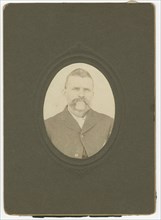 Photograph of a man with a mustache wearing a dark jacket, late 19th century. Creator: Unknown.