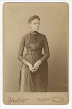Cabinet card of a woman, 1885-1892. Creator: William J. Kuebler.