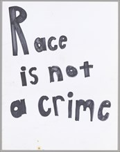 Poster reading "Race is not a crime" used at Baltimore protests, April 2015. Creator: Unknown.