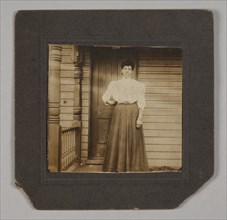 Photographic print of a woman on a porch, early 20th century. Creator: William O. Turner.