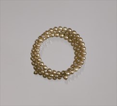 Gold pearl coil bracelet from Mae's Millinery Shop, 1941-1994. Creator: Unknown.