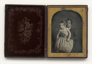 Daguerreotype of a boy holding a white baby, 1850s. Creator: Unknown.