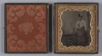 Tintype of a woman wearing a white hat and holding a book, 1880s. Creator: Unknown.